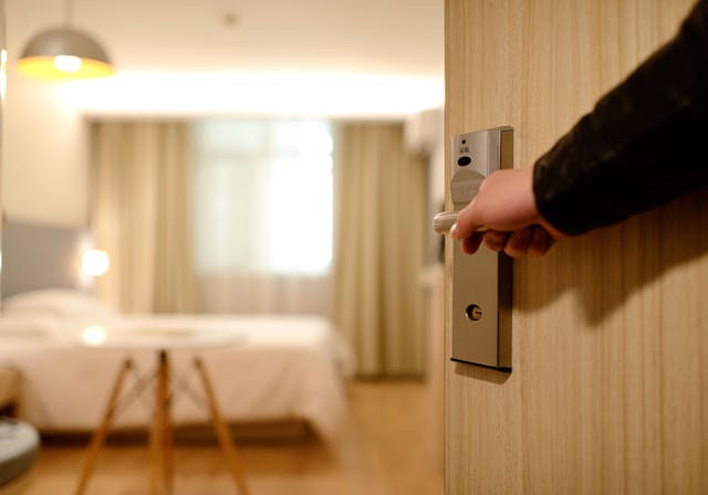 Person opening door to a hotel room